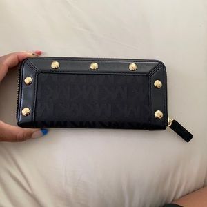 Gently used Michael Kors Black and Gold wallet.